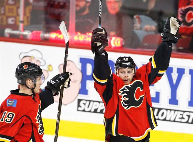 Calgary Flames' Matt Stajan, right, celebrates his goal with Matthew Tkachuk against the Anaheim Ducks during second period NHL action in Calgary, Alta., Sunday, Dec. 4, 2016. 