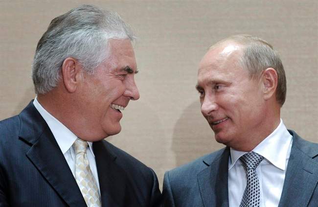 In this Aug. 30, 2011, file photo, Russian Prime Minister Vladimir Putin, right, and Rex Tillerson, former ExxonMobil CEO smile during a signing ceremony in the Black Sea resort of Sochi, Russia.