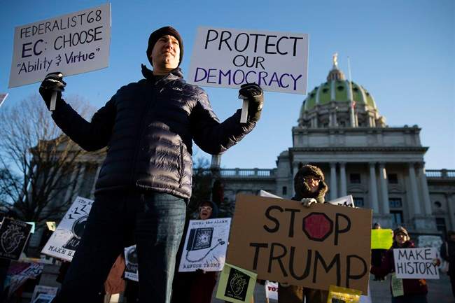 Protesters demonstrate ahead of Pennsylvania's 58th Electoral College at the state Capitol in Harrisburg, Pa., Monday, Dec. 19, 2016.