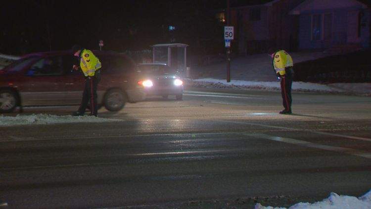 Police officers investigate after a 59-year-old woman was struck by a vehicle at 52 Street & Temple Drive NE. 