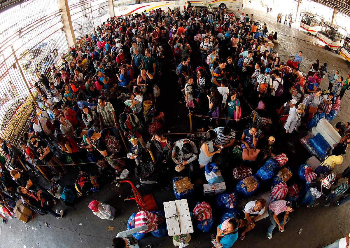 Filipinos board buses before Christmas Day at a bus terminal in Pasay city, south of Manila. 
