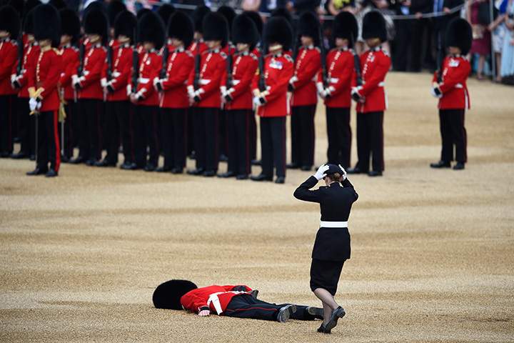 A Guardsman faints during the annual Trooping the Colour ceremony in central London, England on June 11, 2016.