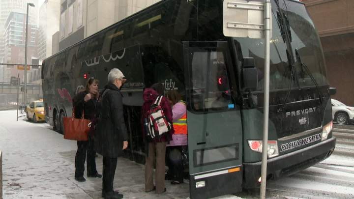 Passengers boarding a Red Arrow bus for holiday travel.