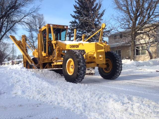 A grader plows a Winnipeg street. 