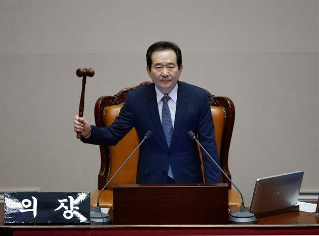 South Korea's Assembly Speaker Chung Sye-kyun presides over a plenary session to vote on the impeachment bill of South Korean President Park Geun-hye at the National Assembly in Seoul Friday, Dec. 9, 2016. South Korean lawmakers on Friday impeached Park, a stunning and swift fall for the country‚Äôs first female leader amid protests that drew millions into the streets in united fury. (Kim Hong-Ji/Pool Photo via AP).