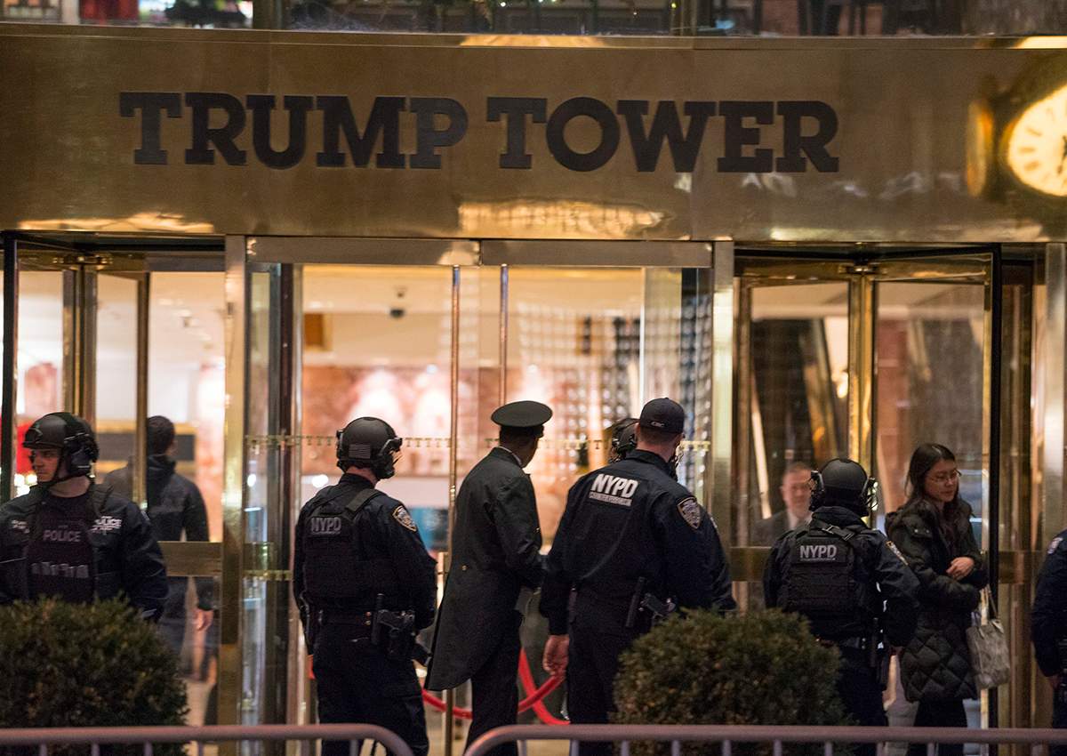 New York police officers and others stand outside the Trump Tower lobby in New York, Tuesday, Dec 27, 2016. Police hastily cleared the lobby of Trump Tower on Tuesday to investigate an unattended backpack, only to find that the bag contained children’s toys.