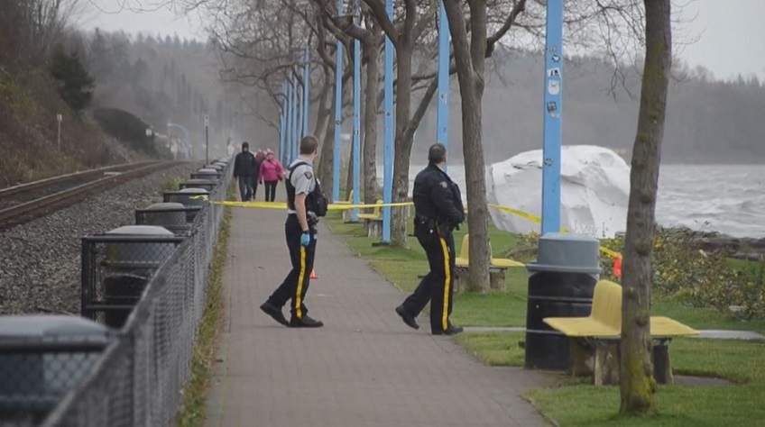 Police investigate the scene in White Rock, B.C., where a body was found washed up on the beach on Dec. 3, 2016. 
