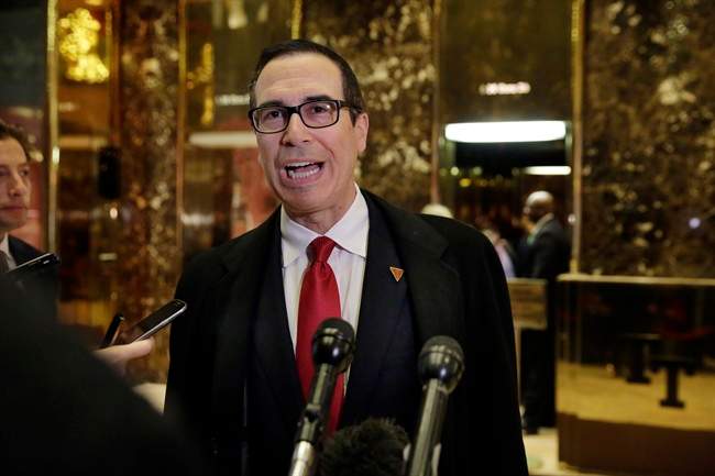 In this Nov. 30, 2016 file photo, Treasury Secretary-designate Steven Mnuchin talks to reporters as he arrives at Trump Tower in New York.