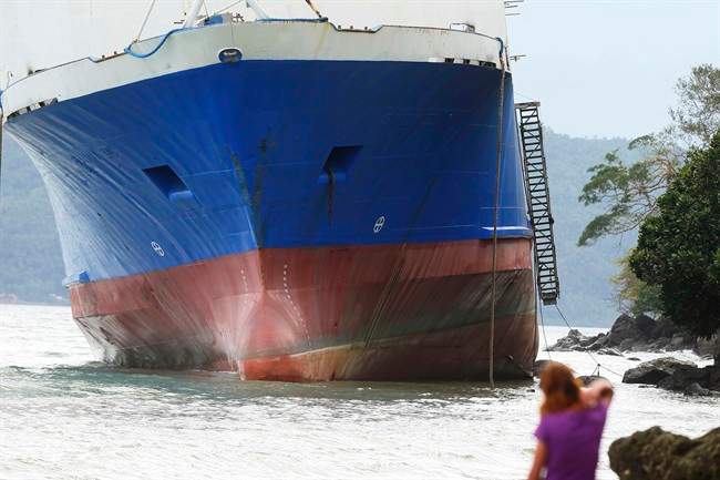 The passenger ferry Shuttle Roro 5 is shown resting by shoreline after being swept by typhoon Nock-Ten a day after Christmas Monday, Dec. 26, 2016 at Mabini township, Batangas province, south of Manila, Philippines. The powerful typhoon slammed into the eastern Philippines on Christmas Day, spoiling the biggest holiday in Asia's largest Catholic nation but weakened slightly on Monday as it roared toward a congested region near the country's capital, officials said.