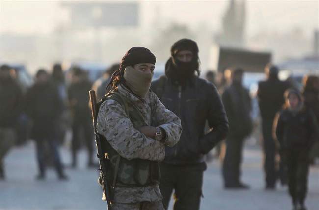 Armed Syrian fighters evacuated from the embattled Syrian city of Aleppo during the ceasefire arrive at a refugee camp in Rashidin, near Idlib, Syria, Tuesday, Dec. 20, 2016. 
