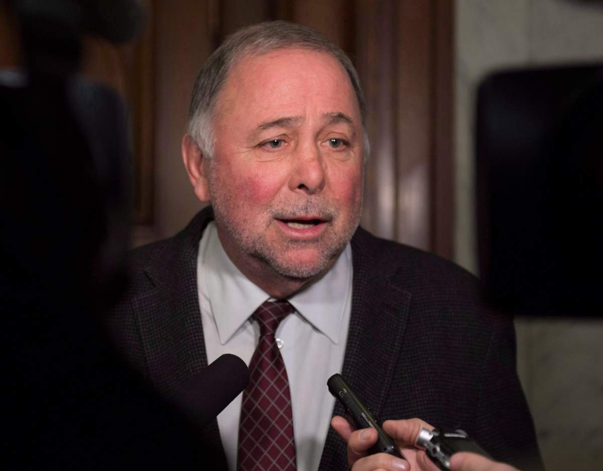 Quebec Agriculture Minister Pierre Paradis responds to reporters questions at the entrance to a cabinet meeting at the legislature in Quebec City Wednesday, December 14, 2016.