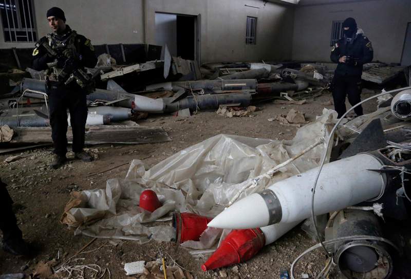 Iraq's special forces troops inspect missiles found in a warehouse in the eastern side of Mosul, Iraq, Jan. 28, 2017. 