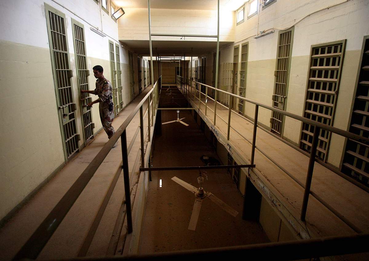  In this Sept. 2, 2006, file photo, an Iraqi army soldier closes the door of a cell, in Abu Ghraib prison on the outskirts of Baghdad, Iraq. 