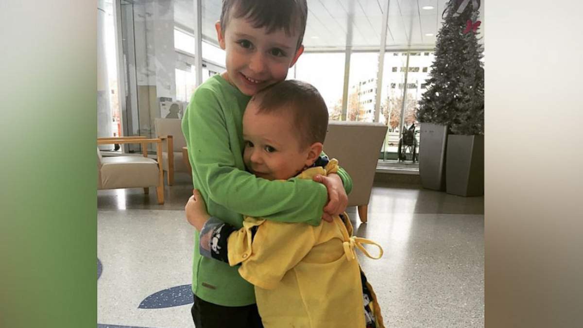 The story behind the powerful photo of newlyweds holding their cancer-stricken son - image