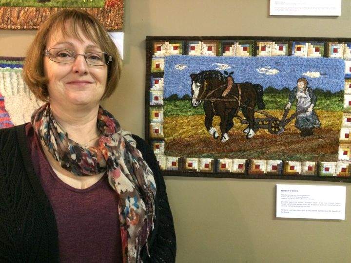 Calgary artist Rebecca Nicholas with her piece showing early farm life in Canada.
