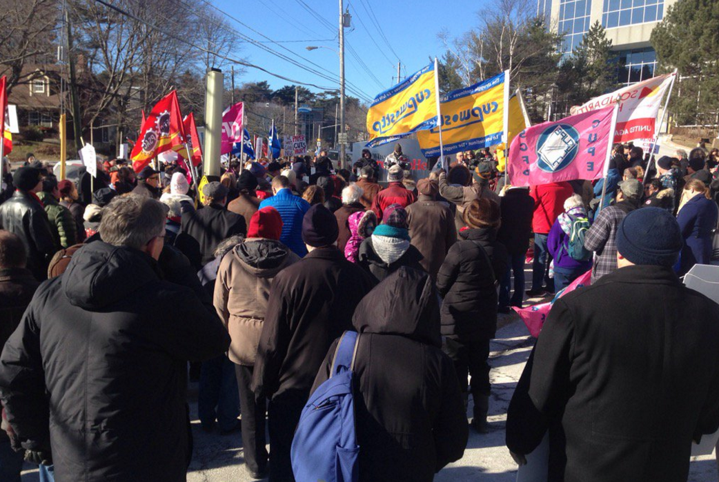 People gather outside the Halifax office of the Chronicle Herald on Joseph Howe Drive for a rally in support of the union representing striking workers at the newspaper. The union has been on strike for one year.