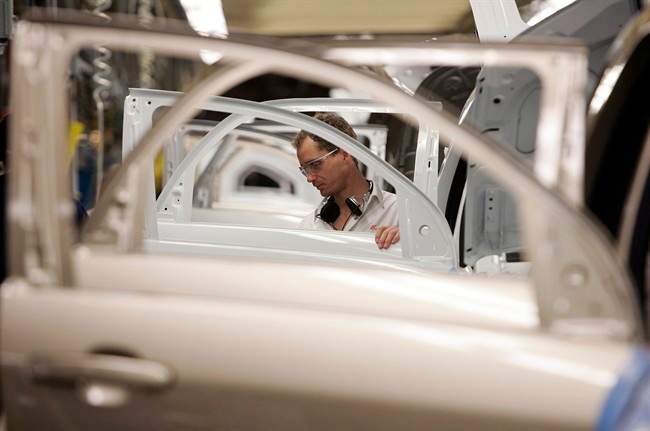 Doors and window openings line up on the Trim line, where window regulators, trim panels and window glass is installed at the CAMI Automotive facility in Ingersoll, Ontario, Thursday, Dec. 21, 2006. 