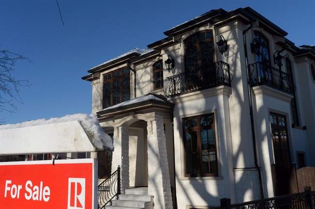 A for sale sign is shown outside a house for sale in Vancouver, Tuesday, Jan.3, 2017.