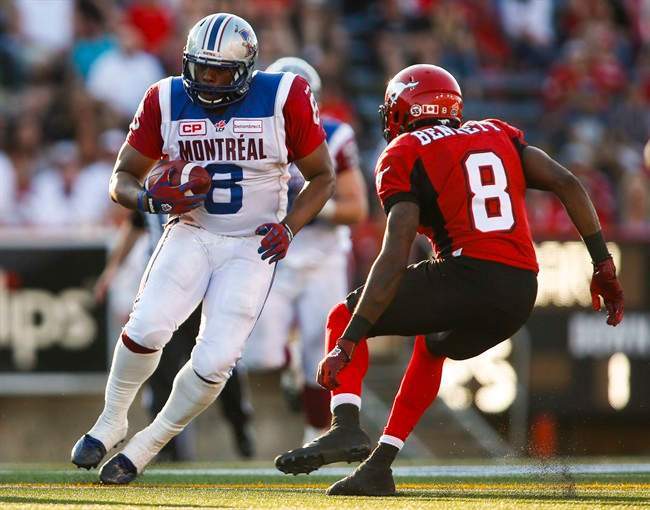 Montreal Alouettes' Nik Lewis, left, tries to get past Calgary Stampeders' Fred Bennett during second half CFL football action in Calgary on Saturday, August 1, 2015. The Alouettes signed veteran slotback Lewis to a two-year contract extension Wednesday.