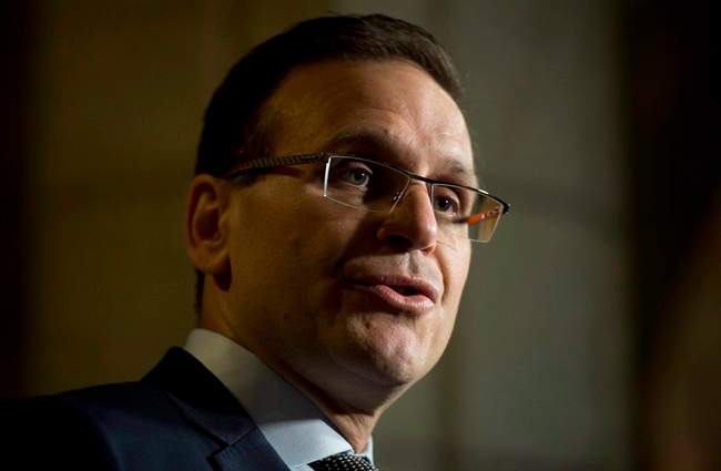 Senate Speaker Leo Housakos speaks with the media in the Foyer of the Senate on Parliament Hill in Ottawa, Tuesday, May 26, 2015. The chairman of the Senate committee charged with overseeing expense rules is firing back at the Liberal point man in the upper chamber over the level of accountability and transparency with senators' spending. THE CANADIAN PRESS/Adrian Wyld.