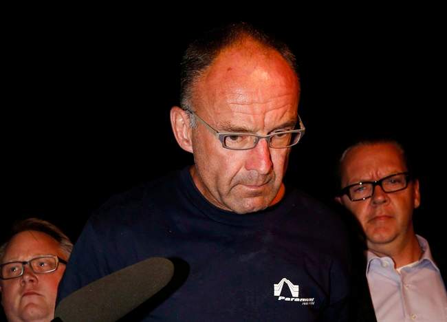 Douglas Garland is escorted into a Calgary police station in connection with the disappearance of Nathan O'Brien and his grandparents in Calgary, Alta., on July 14, 2014. 