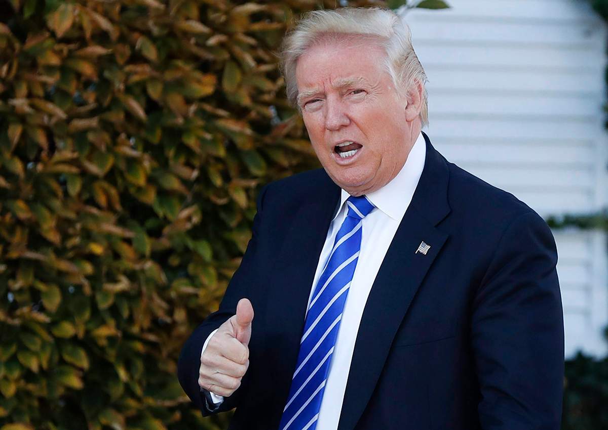 In this Saturday, Nov. 19, 2016 file photo, President-elect Donald Trump gives the thumbs-up as he arrive at the Trump National Golf Club Bedminster clubhouse in Bedminster, N.J. 