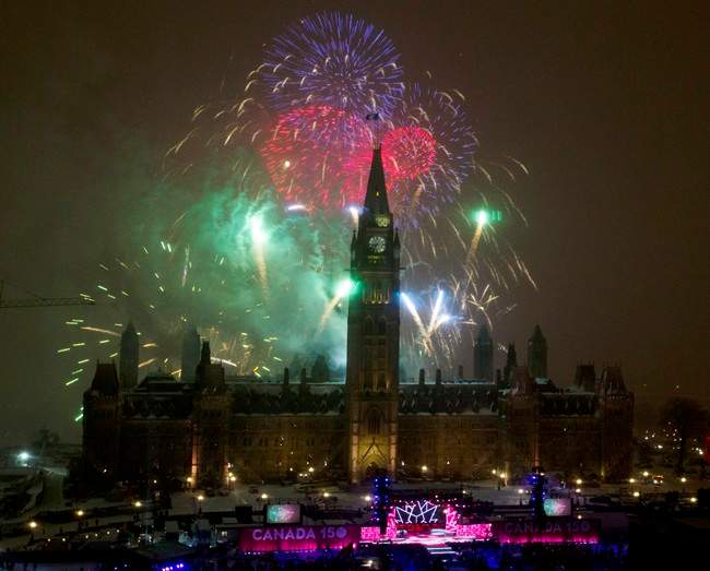 Fireworks explode over Parliament Hill to celebrate New Year's Eve and Canada's 150th anniversary of Confederation on Parliament Hill in Ottawa, Saturday, December 31, 2016.