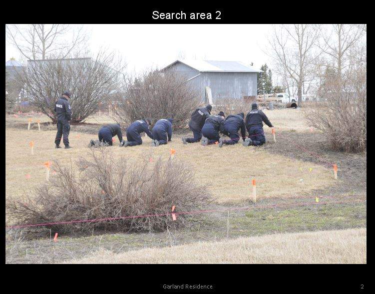 Officers searching the Garland property. Photo presented as evidence Jan. 25, 2017.