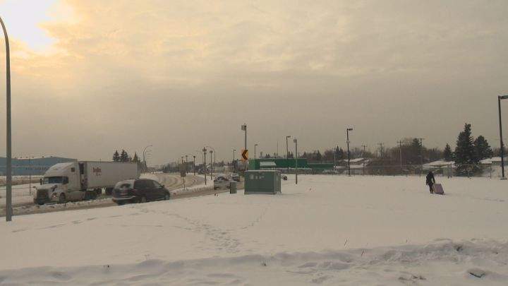 A woman treks through the snow with her suitcase after getting off of a Greyhound bus on Jan. 9, 2017.