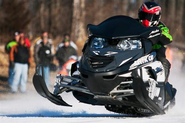 FILE - In this Jan. 6, 2013, file photo, Mike Martin, of Galesburg, Ill., drives his Arctic Cat snowmobile during the Annual Prairie Drifters Snowmobile Radar Run at Lake Storey in Galesburg. 