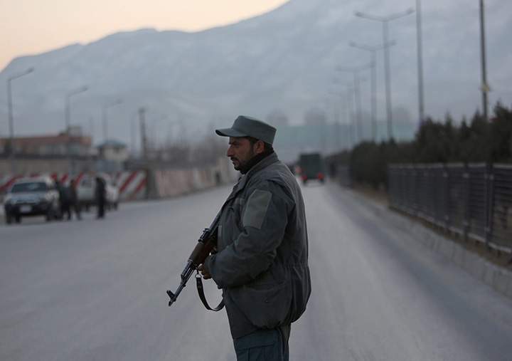 A member of the Afghan security forces stands guard near the site of two blasts in Kabul, Afghanistan, Tuesday, Jan. 10, 2017. 
