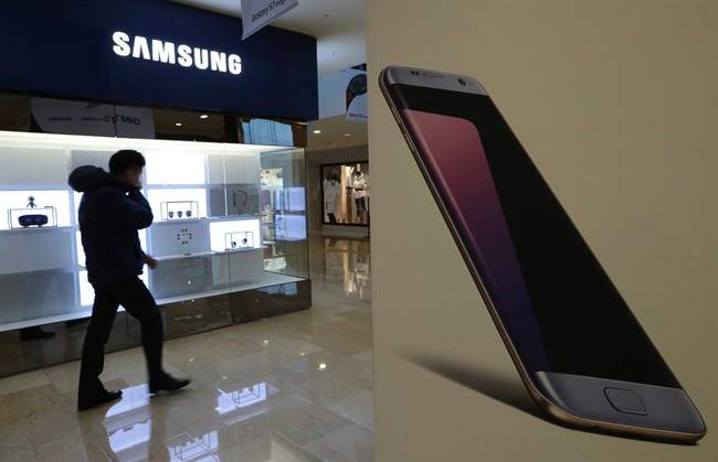 A man walks by an advertisement of the Samsung Electronics Galaxy smartphone in Seoul, South Korea on Friday, Jan. 6, 2017. Samsung Electronics Co. said Friday that its profits in the last quarter of 2016 surged 50 percent to the highest level in more than three years, despite the Galaxy Note 7 fiasco.