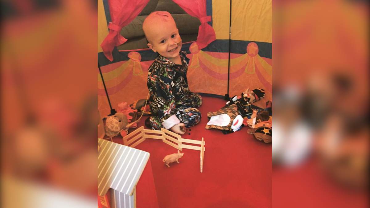 The story behind the powerful photo of newlyweds holding their cancer-stricken son - image