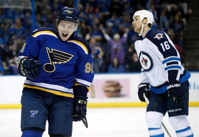 St. Louis Blues' Vladimir Tarasenko, of Russia, celebrates after scoring as Winnipeg Jets' Shawn Matthias (16) skates past during the second period of an NHL hockey game Tuesday, Jan. 31, 2017.