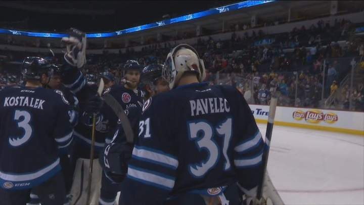 The Manitoba Moose celebrate a 2-1 win with goalie Ondrej Pavelec.