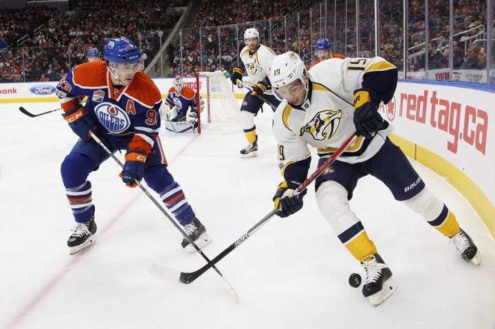 Nashville Predators' Calle Jarnkrok (19) and Edmonton Oilers' Ryan Nugent-Hopkins (93) battle in the corner during first period NHL action in Edmonton, Alta., on Friday January 20, 2017. 