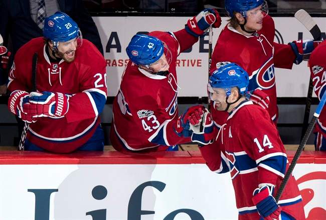 Montreal Canadiens centre Tomas Plekanec (14) celebrates his goal against the Calgary Flames with teammates left wing Daniel Carr (43) and defenceman Zach Redmond (20) during second period NHL hockey action Tuesday, January 24, 2017 in Montreal.