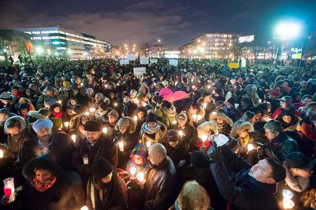 People attend a vigil for victims of the mosque shooting in Quebec City Monday, January 30, 2017 in Montreal.