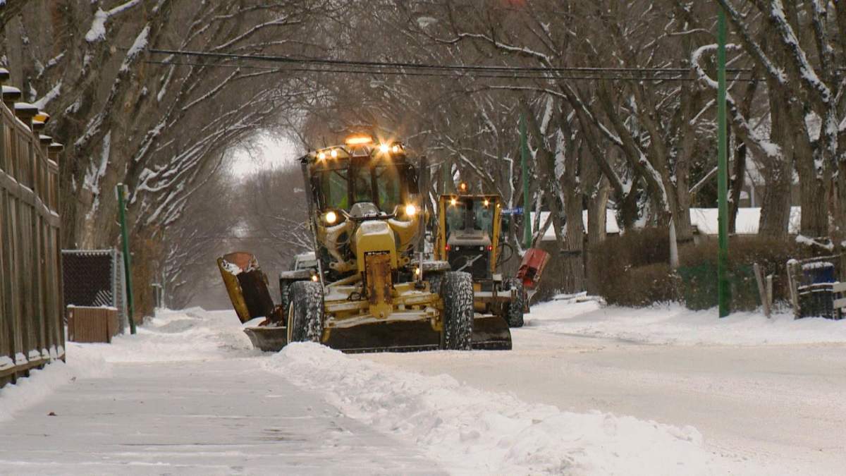 A snow plow clears a snowy Calgary road on Monday, Jan. 2, 2017. 