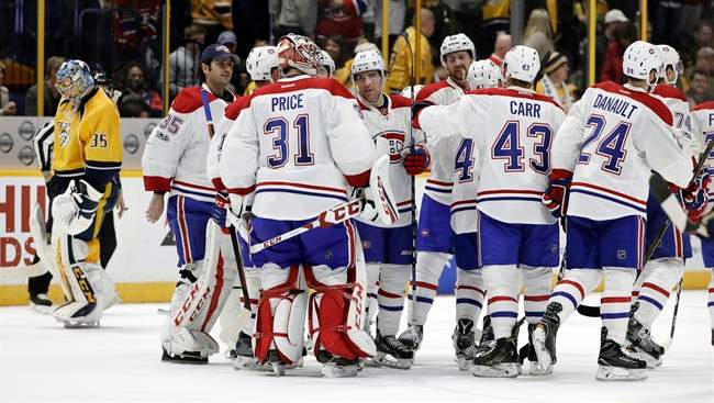 Montreal Canadiens players celebrate with goalie Carey Price (31) as Nashville Predators goalie Pekka Rinne, left, of Finland, skates to the bench after the Canadiens beat the Predators 2-1 in overtime at an NHL hockey game Tuesday, Jan. 3, 2017, in Nashville, Tenn.