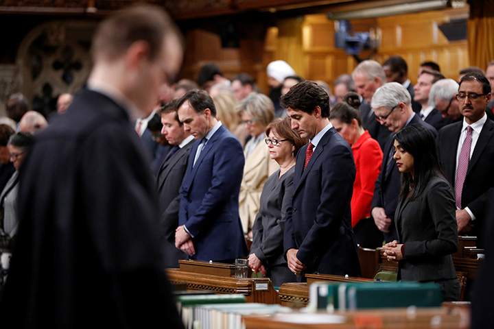 Prime Minister Justin Trudeau joins fellow MPs in a moment of silence after delivering a statement on a deadly shooting at a Quebec City mosque, in the House of Commons on Parliament Hill in Ottawa, January 30, 2017.