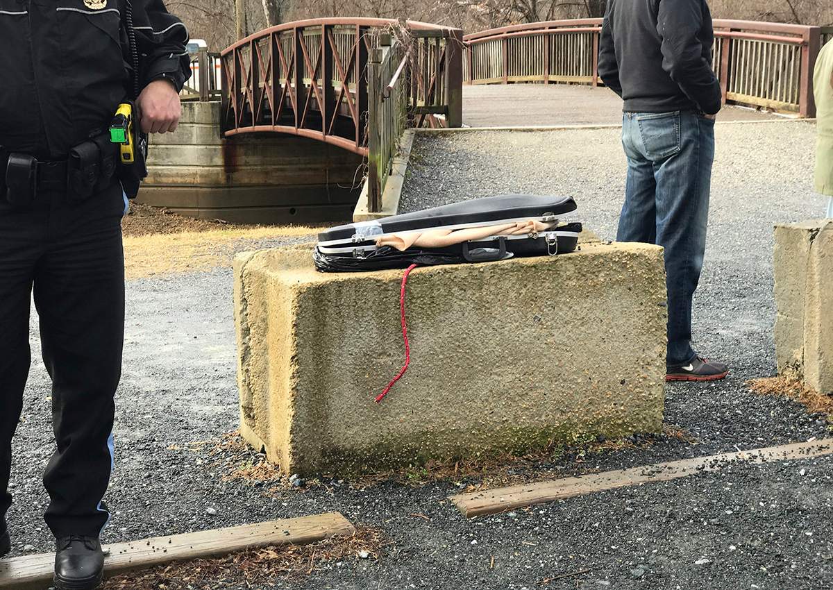 This image provided by Barbara Joan Saffir, shows police standing near a violin case along the Potomac River in Washington, Wednesday, Jan. 4, 2017. 