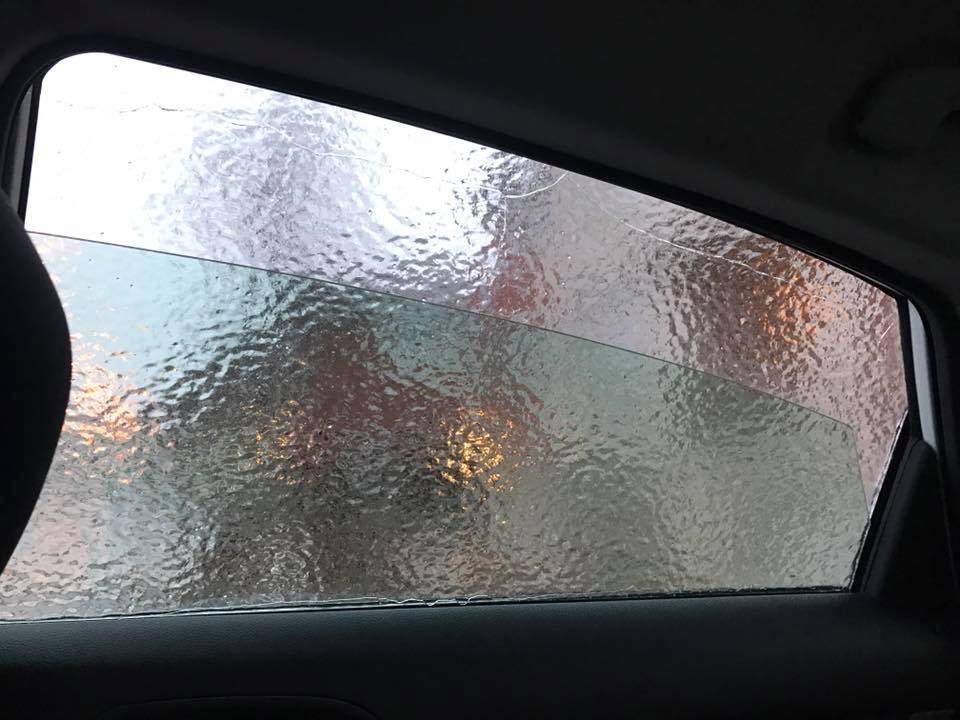 Winding down the car window.