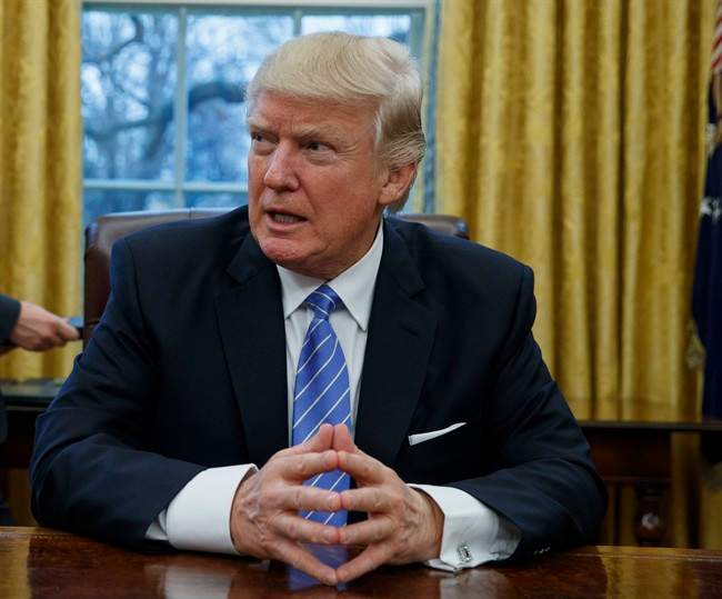 In this Jan. 23, 2017 file photo, President Donald Trump sits at his desk in the Oval Office of the White House in Washington.
