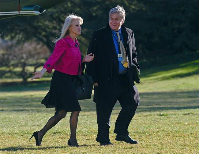 In this Jan. 26, 2017, photo White House counselor Kellyanne Conway, left, and senior adviser Steve Bannon, right, walk on the South Lawn of the White House in Washington, after returning via Marine One from a trip to Philadelphia with President Donald Trump.