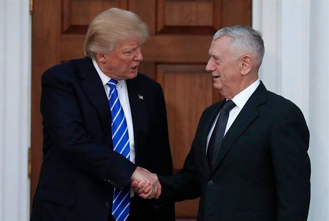 In this Nov. 19, 2016, file photo, President-elect Donald Trump shakes hands with retired Marine Gen. James Mattis as he leaves Trump National Golf Club Bedminster clubhouse in Bedminster, N.J. Mattis is an outspoken critic of Iran, calling it the biggest threat to stability in the Mideast.