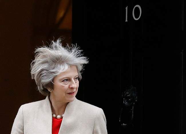 Britain's Prime Minister Theresa May looks out of 10 Downing Street as she wait for the arrival the Prime Minister of New Zealand Bill English at 10 Downing Street in London, Friday, Jan. 13, 2017. (AP Photo/Frank Augstein).