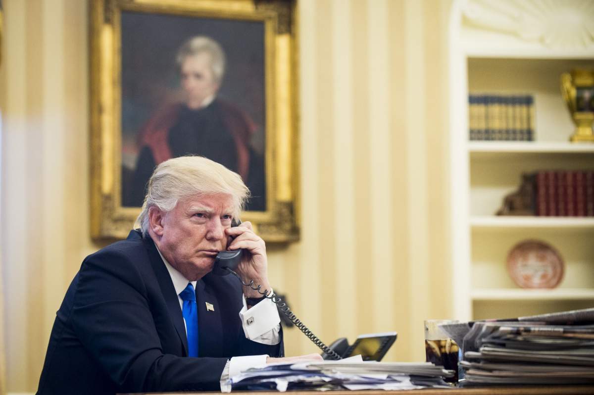 United States President Donald Trump speaks on the phone with Prime Minister of Australia, Malcolm Turnbull in the Oval Office.