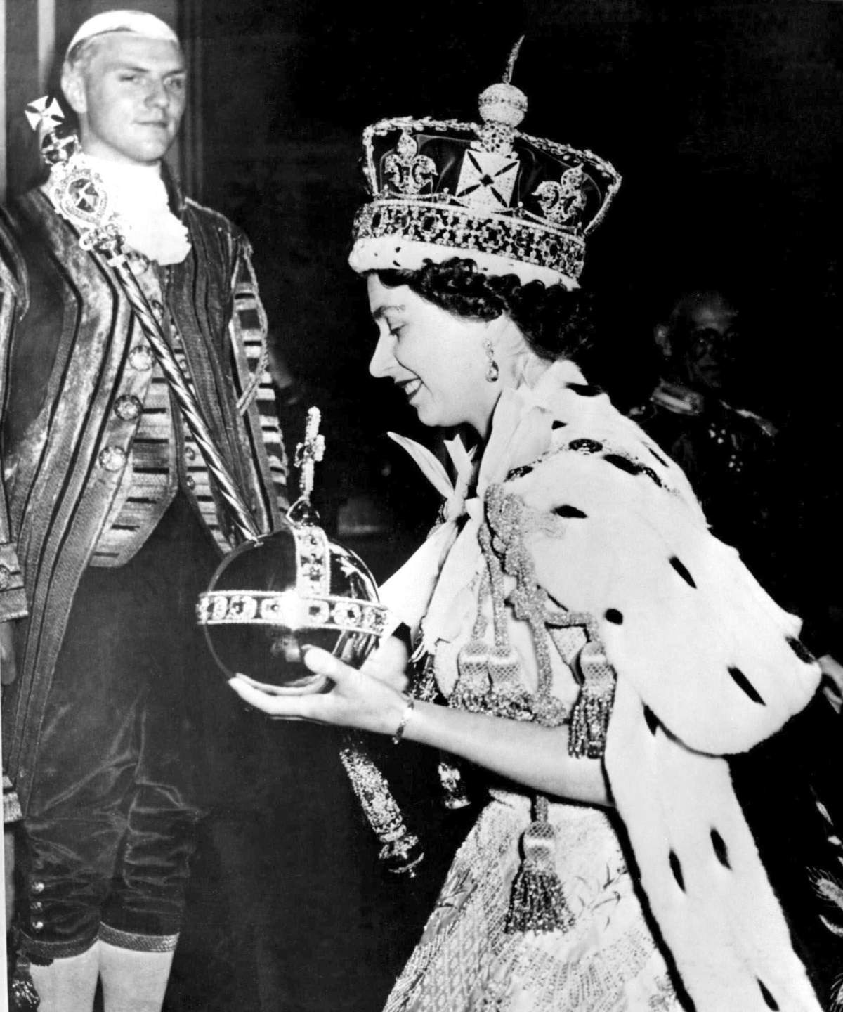 FILE – In this June 2, 1953 file photo, Britain’s Queen Elizabeth II wearing the bejeweled Imperial Crown and carrying the Orb and Scepter with Cross, leaves Westminster Abbey, London, at the end of her coronation ceremony. On Monday Feb. 6, 2017, Queen Elizabeth II marks her Sapphire Jubilee, becoming the first British monarch to reign for 65 years.