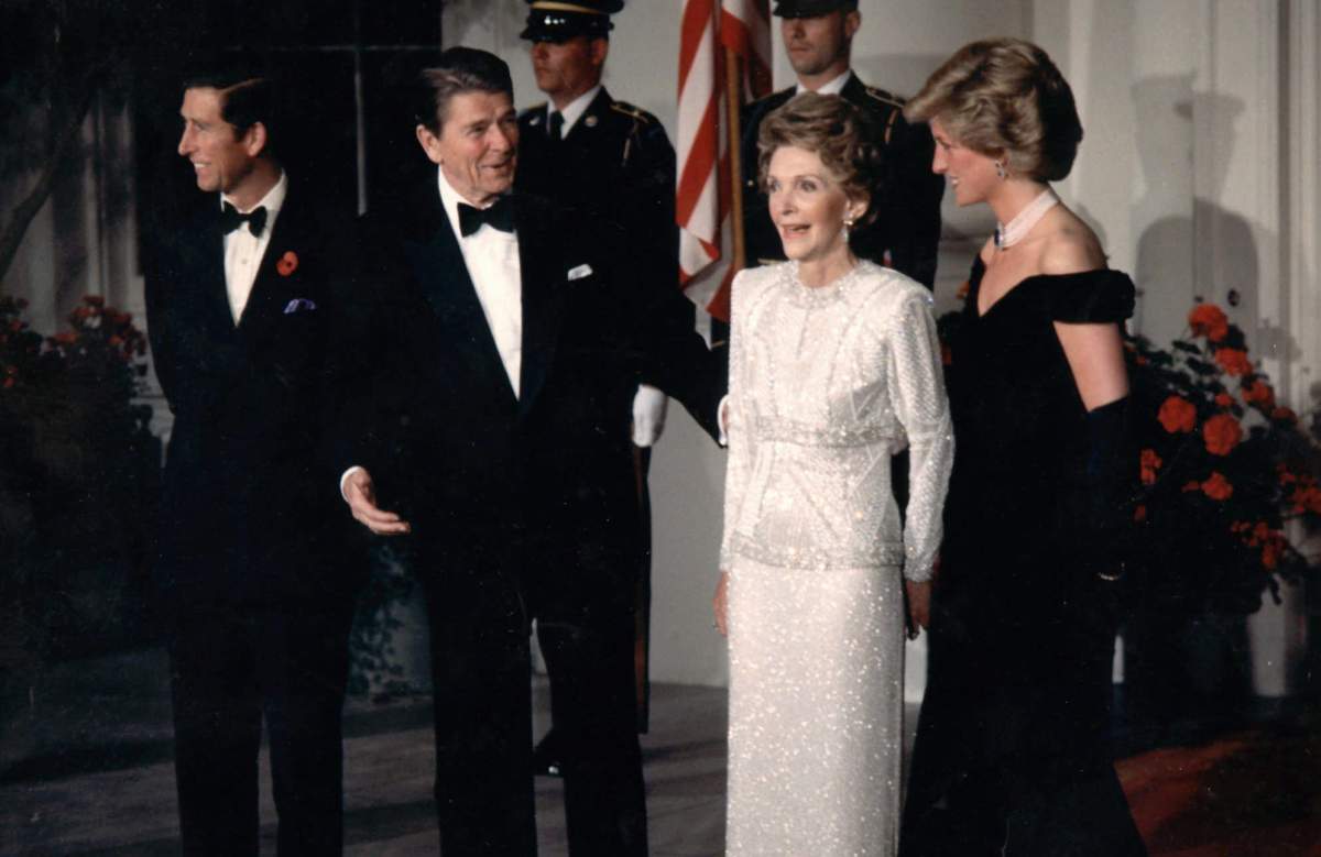 FILE – In this Nov. 9, 1985 file photo, Diana, Princess of Wales, left, speaks with U.S President Ronald Reagan and his wife Nancy during a visit to the White House in Washington. This outfit is featured in an exhibition of 25 dresses and outfits worn by Diana entitled “Diana: Her Fashion Story” at Kensington Palace in London, opening on Friday, Feb. 24, 2017. (AP Photo,file)